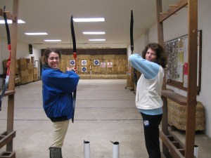Mom and daughter shooting arrows towards a target