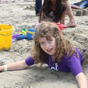 girl with autism playing in sand