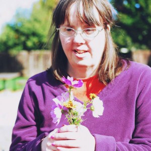 Woman with Down Syndrome holding flowers