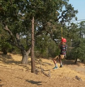 Young teen with autism going down a zipline